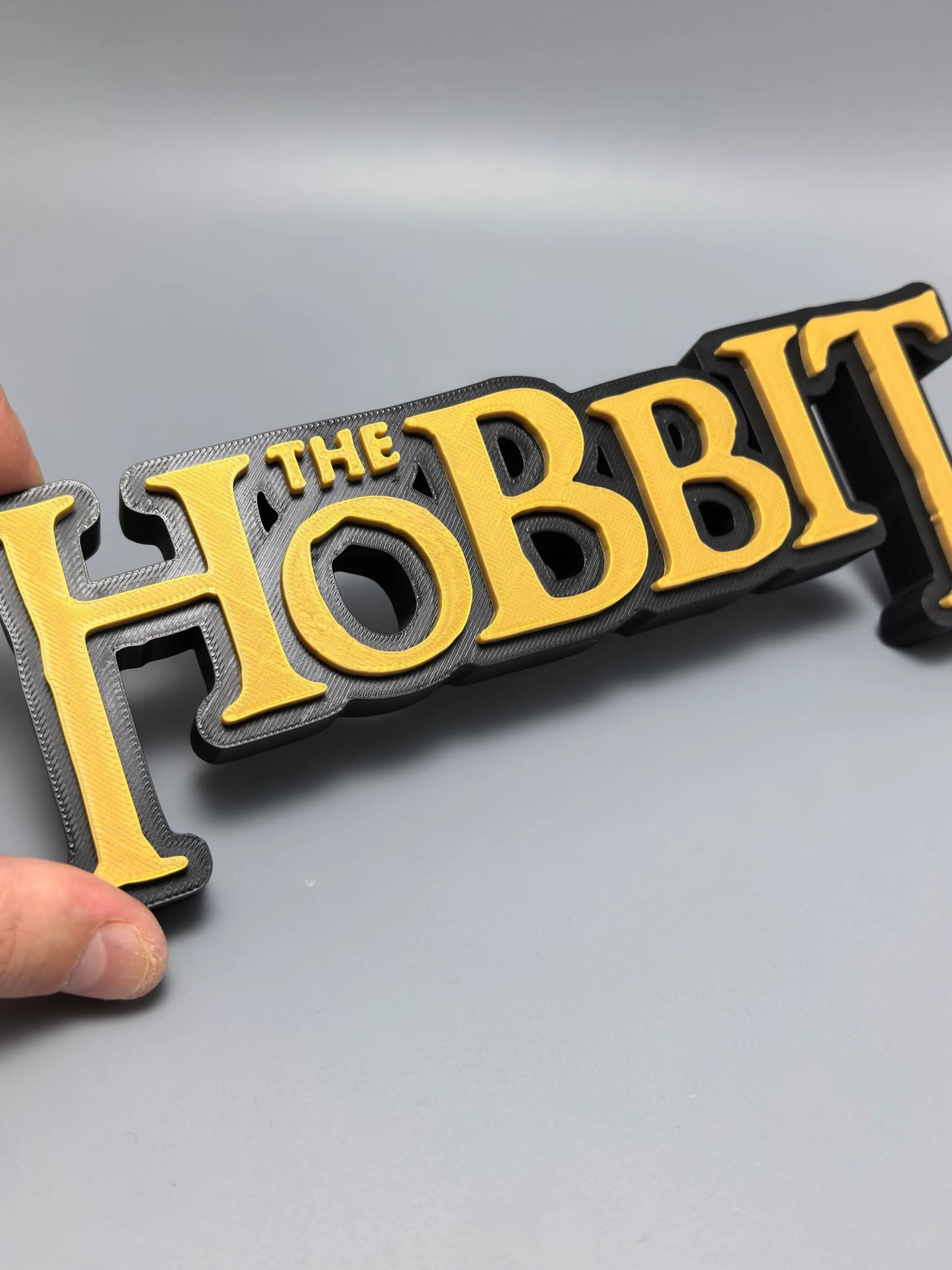 The Hobbit logo display sign close view